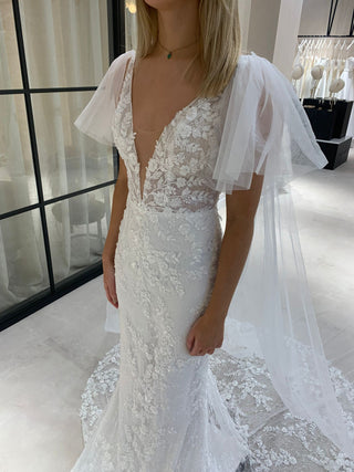 Elegant ivory bridal dress featuring delicate floral embroidery, sweetheart neckline, sheer puff sleeves, and a flowy A-line tulle design, ideal for fairytale-inspired weddings