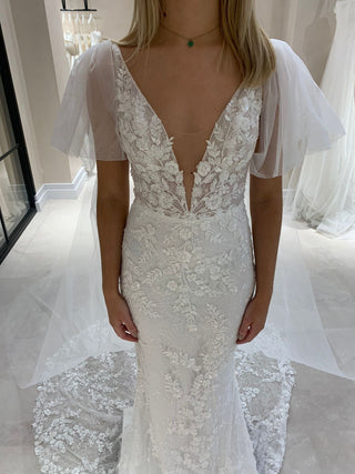 Ivory A-line wedding gown with intricate 3D floral lace applique, sweetheart neckline, sheer puff sleeves, and a floor-length tulle silhouette, perfect for romantic and modern bridal looks