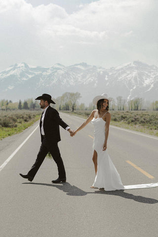 Modern wedding dress featuring lightweight satin fabric, a draped bodice, and a high slit, blending simplicity with a touch of glamour.






