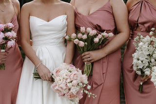 Modern satin wedding gown with a sweetheart neckline, subtle ruching across the bodice, and a voluminous A-line silhouette, ideal for formal ceremonies.