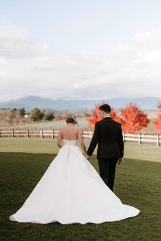 Sophisticated strapless wedding dress with a draped bodice and luxurious satin finish, designed with a flattering A-line skirt for effortless elegance.