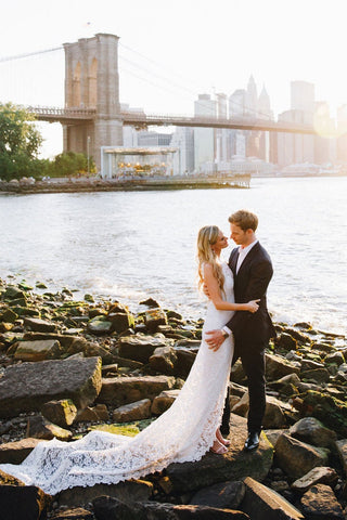 Elegant ivory wedding dress featuring intricate floral embroidery, strapless sweetheart neckline, backless design, and a mermaid fit-and-flare tulle silhouette, ideal for glamorous bridal styles