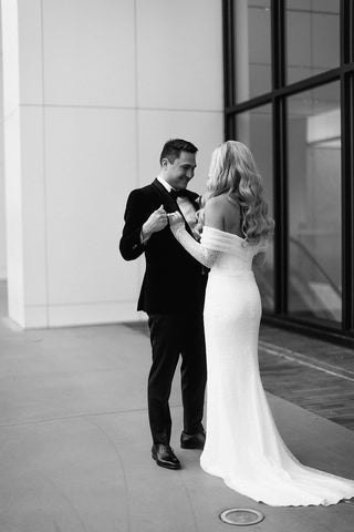 Chic sequin bridal gown with an off-the-shoulder neckline, sheer lace long sleeves, and a sleek floor-length design, complemented by a romantic veil for timeless weddings