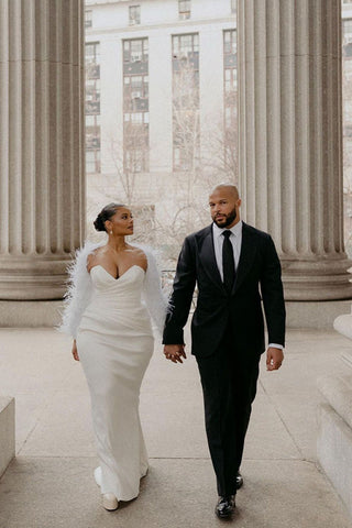 Elegant strapless wedding dress in ivory featuring a ruched bodice, sweetheart neckline, and a flowing floor-length skirt with a long train, ideal for classic bridal styles