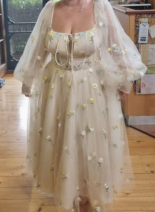 Romantic cream and yellow tea-length ball gown, adorned with floral lace embroidery, long sheer puff sleeves, and a sweetheart neckline, tailored for fairycore or cottagecore-inspired events