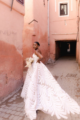 Chic ivory bridal gown with a strapless sweetheart neckline, unique leaf-pattern cutouts, and a dramatic A-line silhouette, tailored for stylish and modern weddings