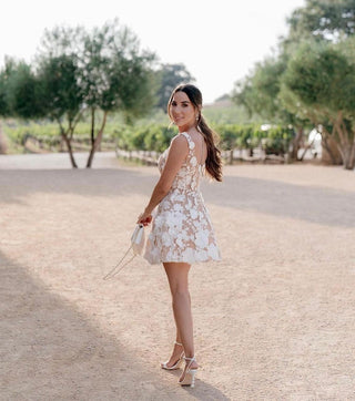 Chic bride in a short lace dress featuring 3D floral embellishments, ideal for receptions or elopements