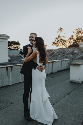 Modern wedding gown featuring clean lines, a square neckline, and a fitted silhouette, ideal for timeless bridal style