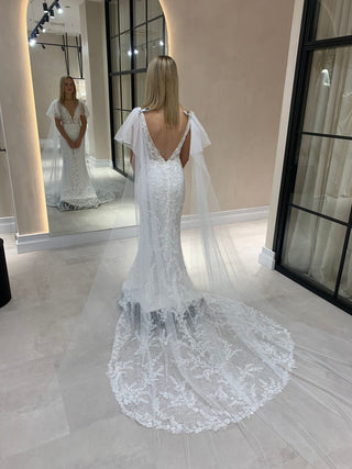 Chic ivory tulle wedding gown with 3D floral lace details, sweetheart neckline, and sheer puff sleeves, tailored for modern and whimsical bridal aesthetics