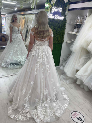 Romantic white tulle ball gown, adorned with lace embroidery, strapless sweetheart neckline, and a flowing A-line design, perfect for elegant and classic bridal occasions