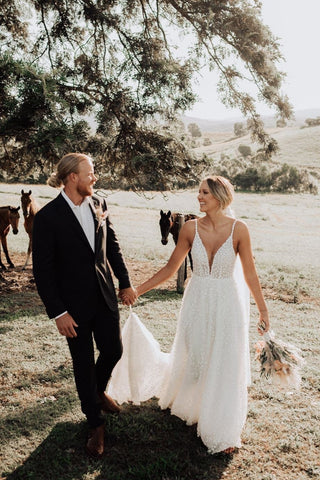 Romantic champagne wedding dress featuring delicate floral embroidery, sweetheart neckline, off-the-shoulder straps, and a mermaid fit-and-flare silhouette, ideal for glamorous bridal celebrations