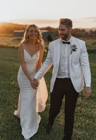 Sleek ivory dress with an understated design, highlighting a stylish draped neckline, fitted waist, and luxurious satin-like texture for a modern yet romantic aesthetic