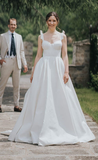 Classic A-line wedding dress featuring a structured corset bodice and delicate shoulder ties, crafted from luxurious satin fabric for an effortlessly elegant look.