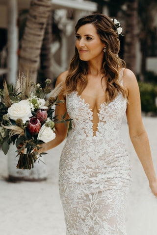 Elegant ivory bridal dress featuring intricate lace embroidery, puff sleeves, sweetheart neckline, and a flowing A-line design, ideal for classic and fairy-tale-inspired weddings