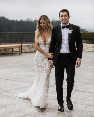 Ivory A-line wedding gown with a sweetheart neckline, floral lace applique, and elegant puff sleeves, designed with a flowy floor-length tulle silhouette, perfect for romantic and timeless bridal occasions