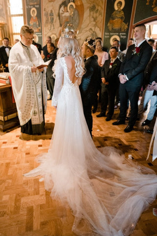 Chic ivory tulle A-line gown with delicate floral lace, deep V-neckline, and sleeveless style, tailored for timeless and sophisticated wedding aesthetics