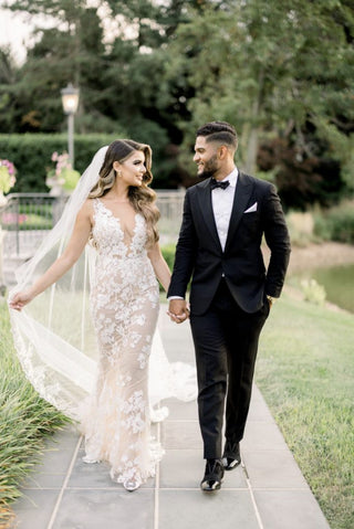 Chic ivory tulle A-line gown with floral lace details, deep V-neckline, and thin straps, tailored for timeless and sophisticated weddings