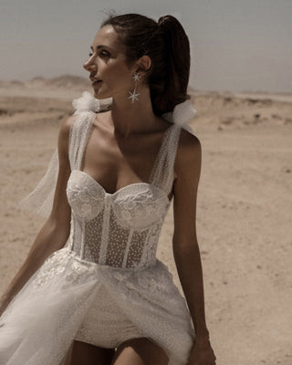 Elegant bridal gown featuring a structured bustier, sparkling embellishments, and soft tulle skirt for a glamorous wedding style,