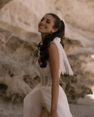 Timeless bridal gown showcasing a sweetheart neckline, sparkling fabric, and delicate shoulder bows for added charm,