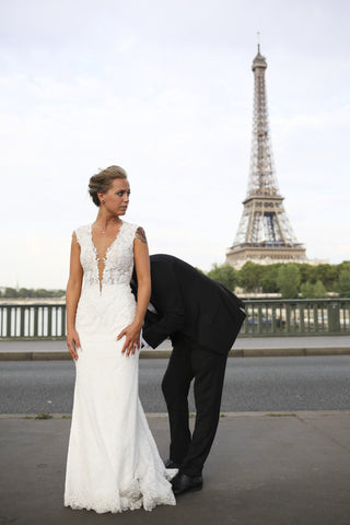 Romantic bridal dress with a dramatic lace train, perfect for a rustic wedding or an intimate outdoor ceremony.