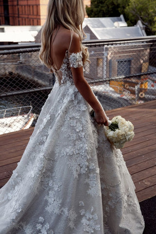 Elegant ivory bridal gown, featuring intricate 3D floral embroidery, sparkling sequins, sweetheart neckline, and off-the-shoulder puff sleeves, ideal for romantic wedding celebrations