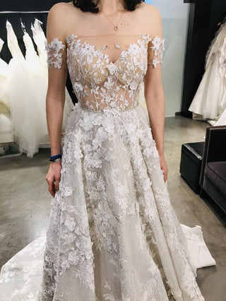 Chic ivory wedding dress with floral lace applique and sequin accents, sweetheart neckline, off-the-shoulder puff sleeves, and an A-line silhouette, tailored for princess-inspired bridal styles