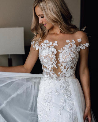 Ivory mermaid wedding dress with 3D floral lace applique and embroidery, strapless sweetheart neckline, illusion off-the-shoulder short sleeves, and sexy fit-and-flare silhouette, perfect for modern bridal looks