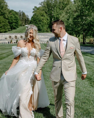 Romantic ivory wedding dress with 3D floral lace applique, deep V-neckline, puffed off-the-shoulder sleeves, and a dramatic high slit, tailored for elegant princess bridal styles