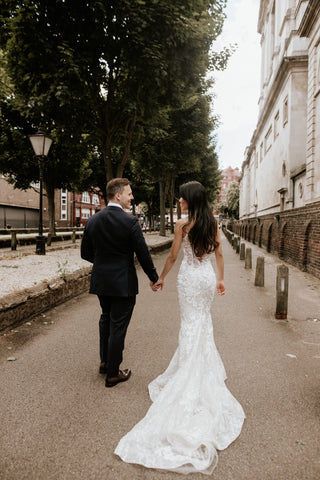 Elegant bridal dress featuring a figure-hugging silhouette, delicate floral embroidery, and sheer panels, paired with sparkling sequins for a modern and luxurious bridal look