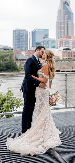 Chic ivory mermaid gown with floral lace applique, sweetheart neckline, thin straps, and a fit-and-flare silhouette, tailored for modern and timeless wedding aesthetics