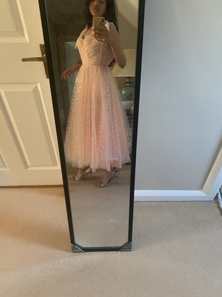 Sophisticated pink tulle dress with sparkling details, thin straps, and a flowy A-line silhouette, accessorised with a cowboy hat, perfect for bohemian-themed weddings or festive events