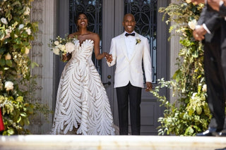 Romantic ivory A-line wedding gown adorned with a strapless neckline and bold leaf-patterned detailing, perfect for contemporary and garden-inspired bridal events