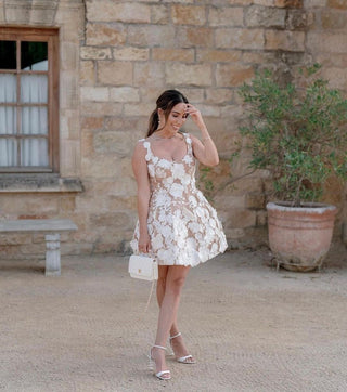 Floral mini dress with intricate lace details and a fitted bodice, perfect for a modern and romantic bridal style