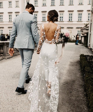 Sophisticated bridal outfit featuring a floral embroidered lace bodice, fitted trousers, and a dramatic lace train, tailored for modern yet elegant wedding celebrations