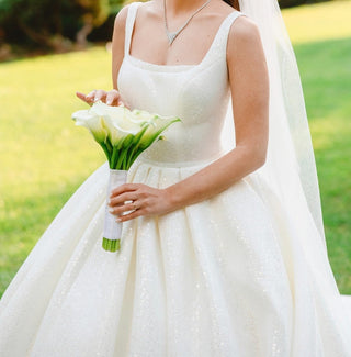 Stunning bridal ball gown with intricate sequin details and a structured design, adding elegance and glamour to any wedding setting.