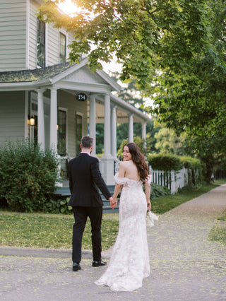 Elegant ivory wedding dress featuring intricate floral embroidery, off-the-shoulder puff sleeves, sweetheart neckline, and mermaid fit-and-flare design, ideal for glamorous bridal occasions