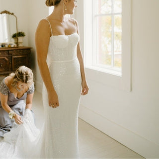 Dazzling mermaid gown with a sweep train and sleek beaded texture, designed for the modern bride who loves a touch of sparkle