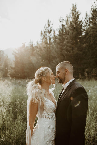 Sophisticated floral lace wedding gown with a plunging neckline, thin straps, and a flattering mermaid-inspired fit, tailored for glamorous and elegant bridal occasions