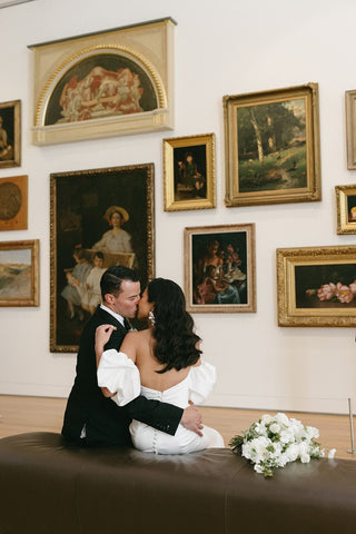 Luxurious ivory satin gown with a strapless bodice, mermaid silhouette, and flowing floor-length design, ideal for timeless and sophisticated wedding celebrations