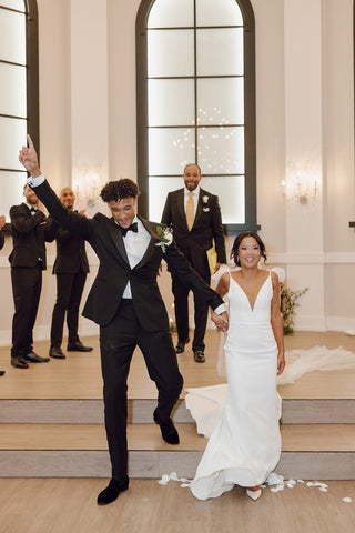 Sophisticated white gown with an effortless design, complemented by subtle floral embellishments and dainty accessories