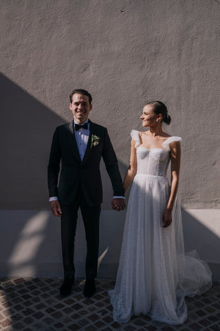 Chic bride wearing a shimmering gown with soft tulle accents and a romantic silhouette, perfect for timeless elegance