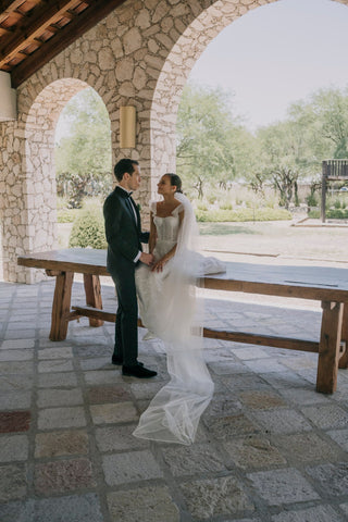 Romantic bridal gown featuring subtle glitter, tulle cap sleeves, and a flowing skirt, designed for a graceful celebration