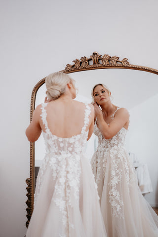 Chic ivory bridal gown with floral applique, sweetheart neckline, off-the-shoulder sleeves, and dramatic A-line tulle design, tailored for modern and elegant weddings