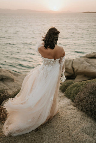 Chic ivory strapless bridal gown with 3D floral applique, deep V-neckline, detachable puff sleeves, and A-line silhouette, perfect for whimsical and fairycore-inspired weddings