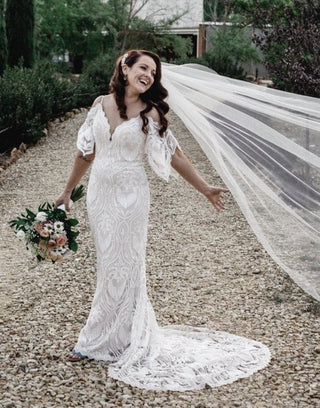 Elegant ivory bridal dress featuring delicate floral embroidery, sweetheart neckline, puff sheer sleeves, and an A-line tulle silhouette, ideal for modern and timeless wedding aesthetics