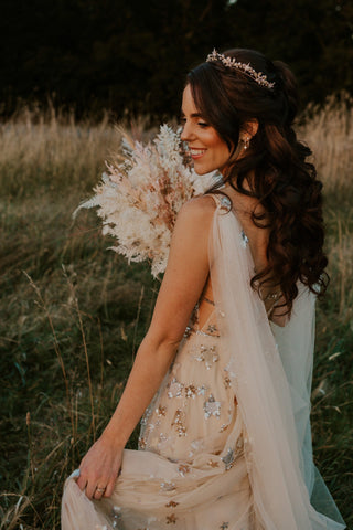 Sophisticated cream glitter gown with celestial starry pattern, deep V-plunge neckline, and elegant floor-length A-line silhouette, tailored for bridal wear, proms, and special celebrations