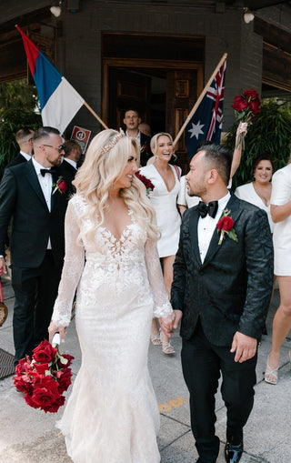 Romantic ivory A-line wedding dress adorned with intricate lace detailing, deep V-neckline, and sleeveless design, perfect for elegant and fairy-tale-inspired bridal occasions