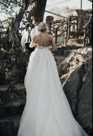 Chic ivory ball gown with floral applique, A-line tulle silhouette, thin spaghetti straps, and a sweetheart neckline, tailored for whimsical boho and fairytale weddings