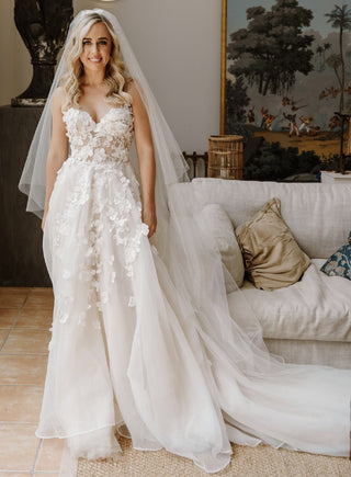 Elegant ivory wedding dress, featuring intricate floral lace embroidery, sweetheart neckline, and lightweight tulle A-line design with delicate spaghetti straps, ideal for romantic bridal looks