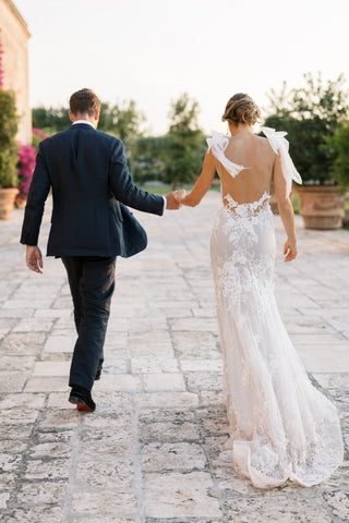 Elegant ivory wedding dress, featuring intricate 3D floral embroidery, cap sleeves, deep V-neckline, and sexy low back, designed for fairytale-inspired bridal looks